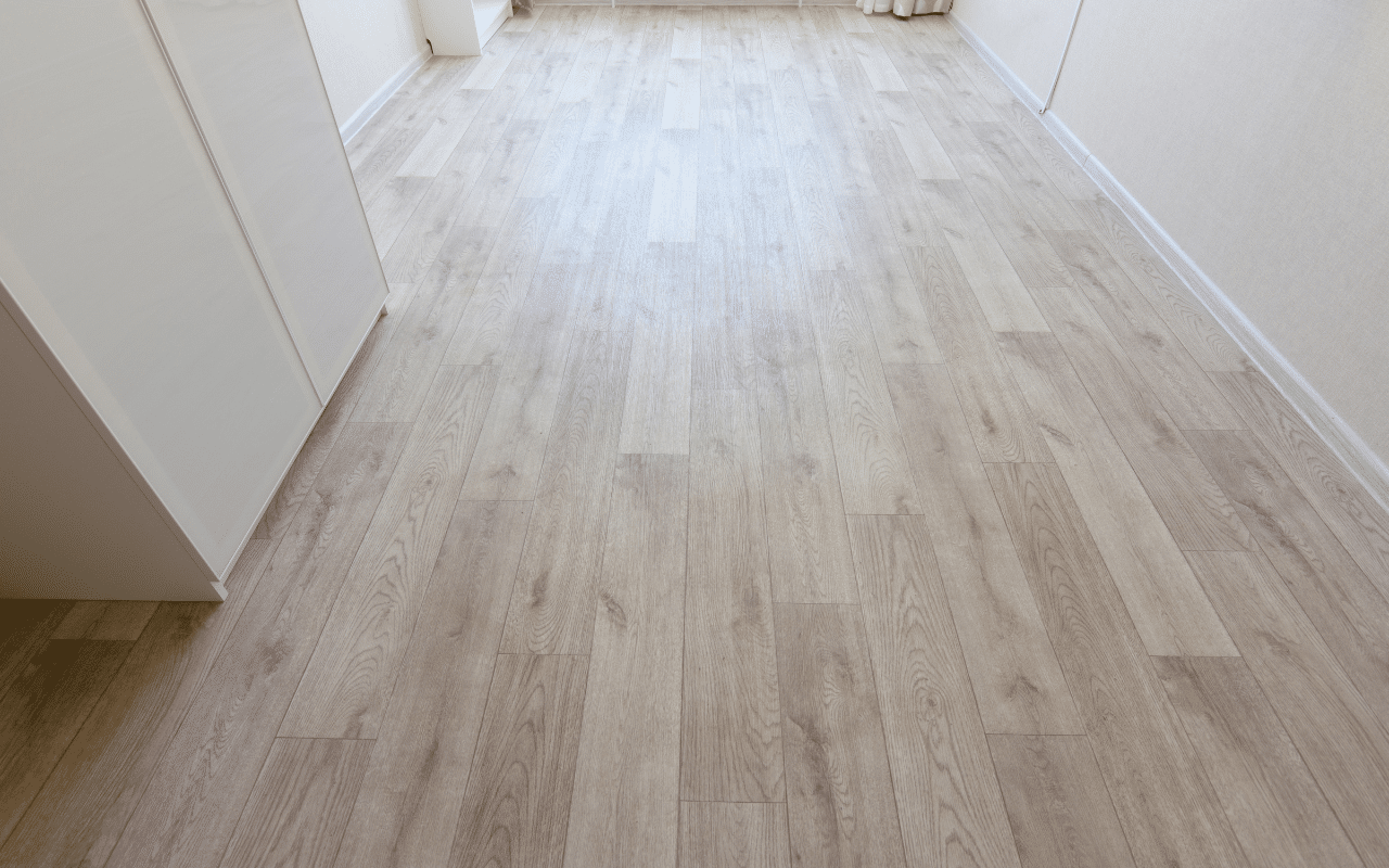 Light wood look linoleum flooring installed in a modern residential hallway interior