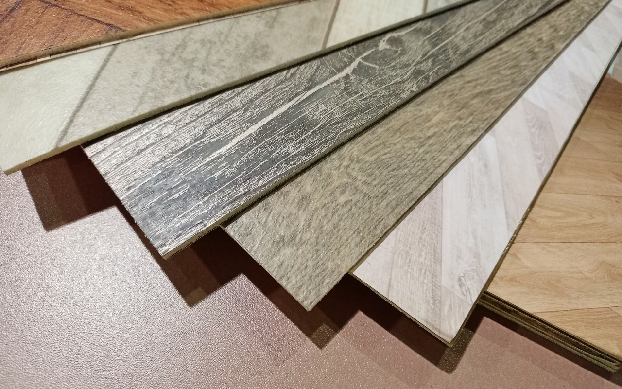 Close up of linoleum flooring samples showing wood grain textures and color variations